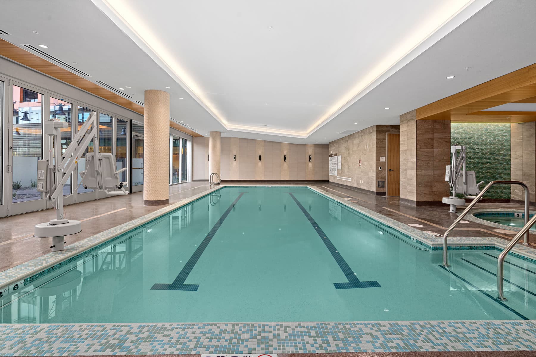 Large indoor pool with views of the courtyard