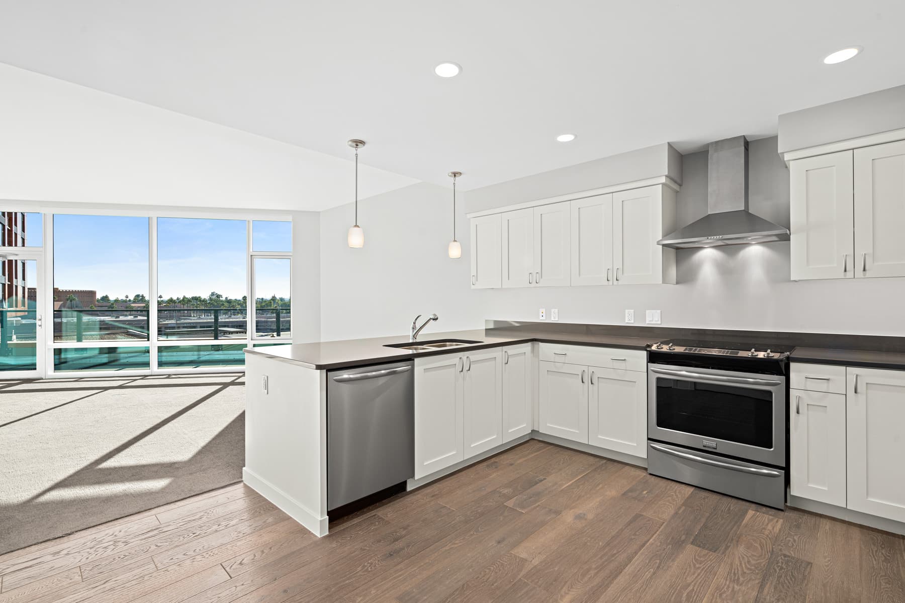 Interior of an apartment kitchen with floor to ceiling windows
