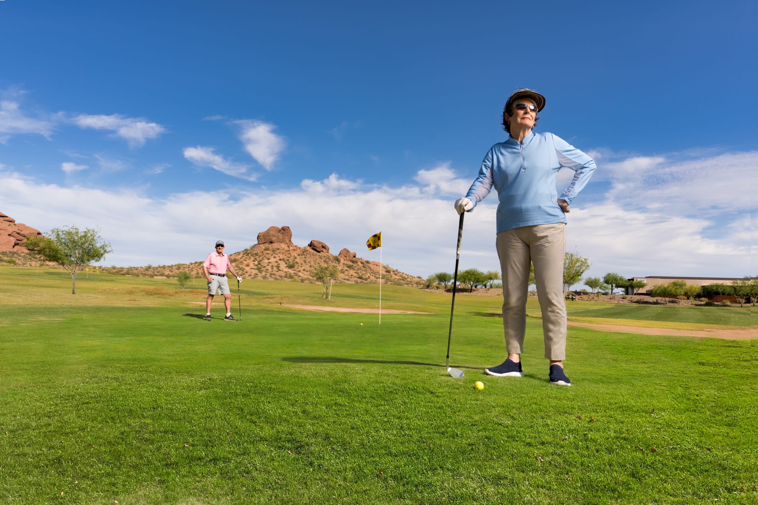Woman outdoors golfing